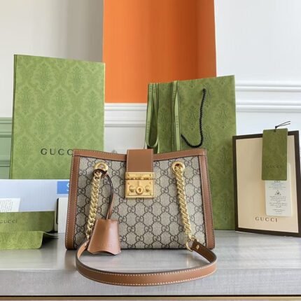 Gucci This chain strap shoulder bag is crafted from canvas with appliquéd striped webbing details for a vintage-inspired design.